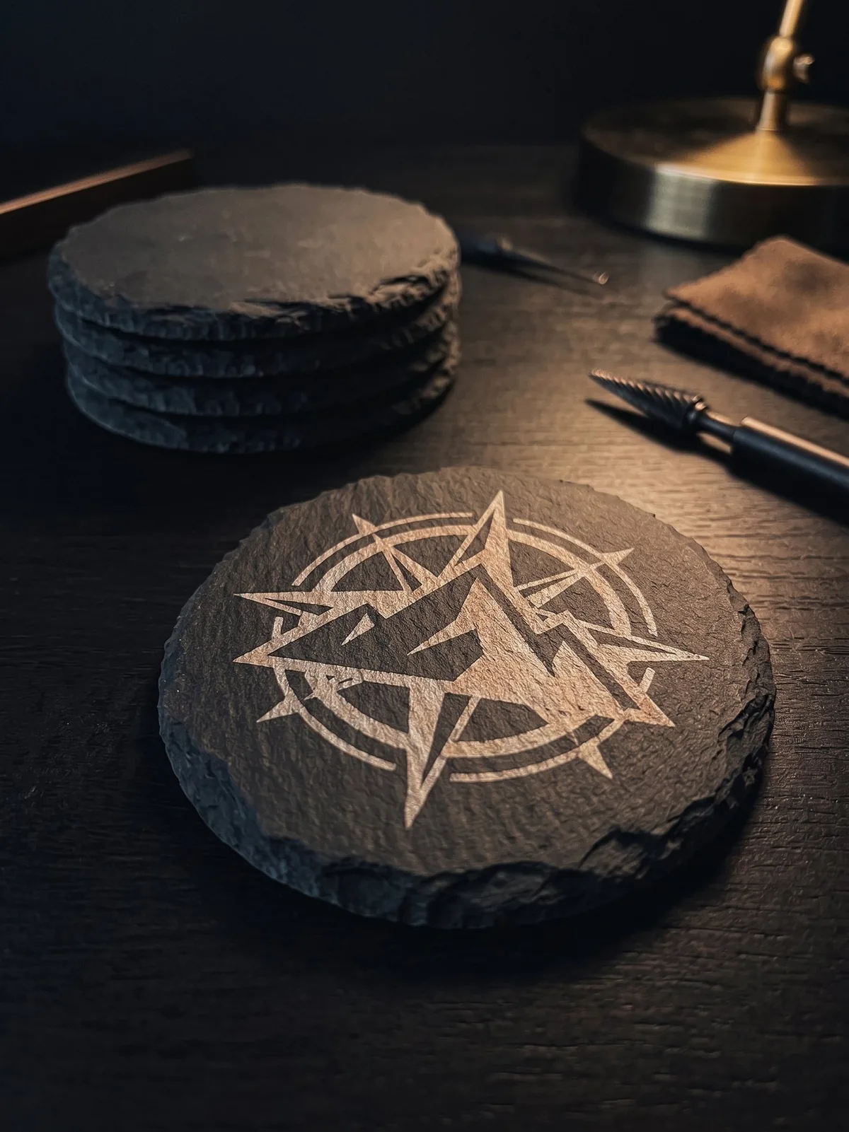 Engraved slate coaster with compass logo